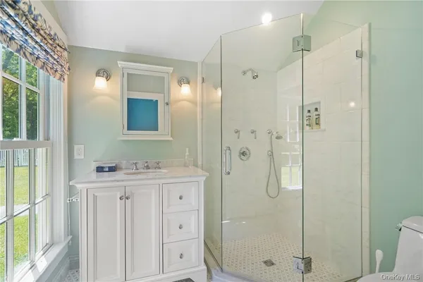 a bathroom with a shower sink and mirror