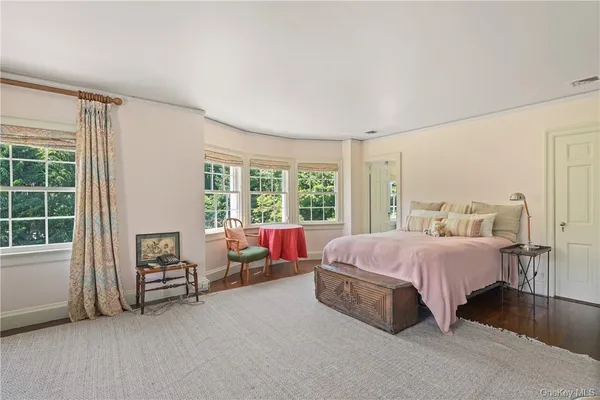 a spacious bedroom with a bed and a window