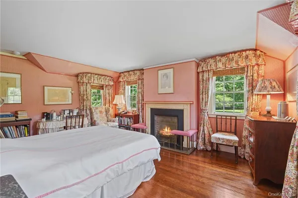 a spacious bedroom with a bed and a fireplace