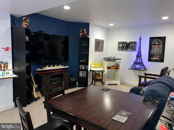 a living room with furniture pool table and flat screen tv