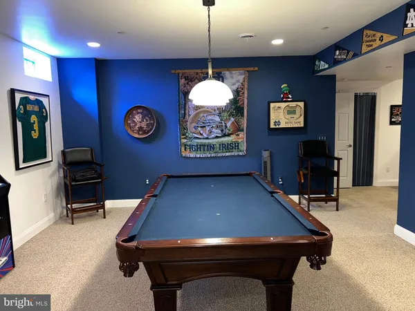 a room with table chairs and a flat screen tv
