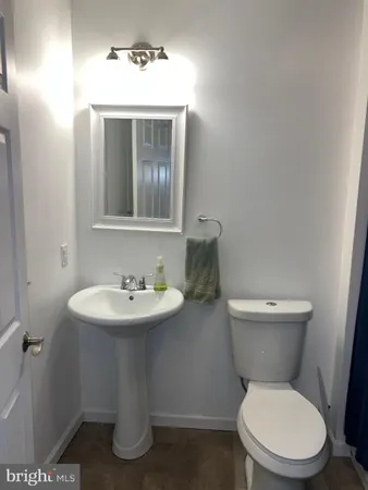 a white toilet sitting next to a bathroom sink
