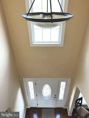 a view of entryway with window and hardwood floor