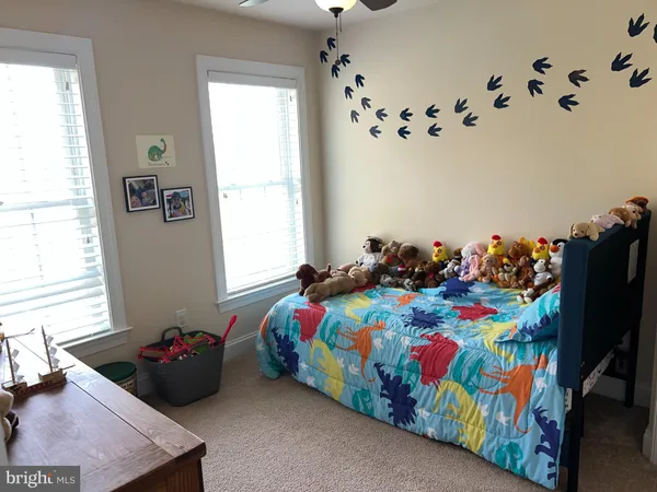 a bedroom with bed and window