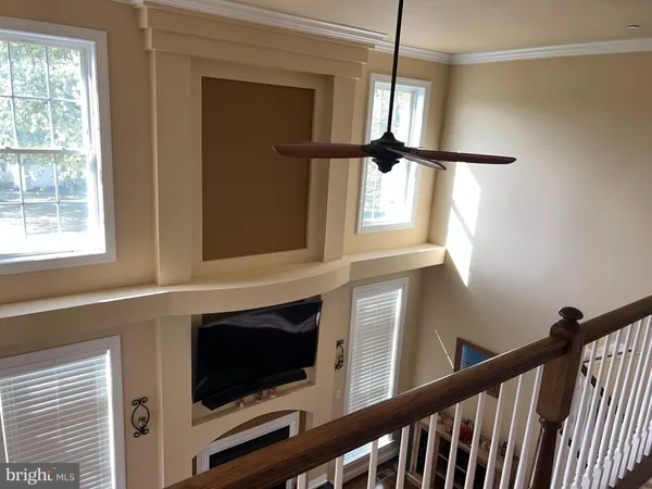 a view of a living room with a window and a ceiling fan