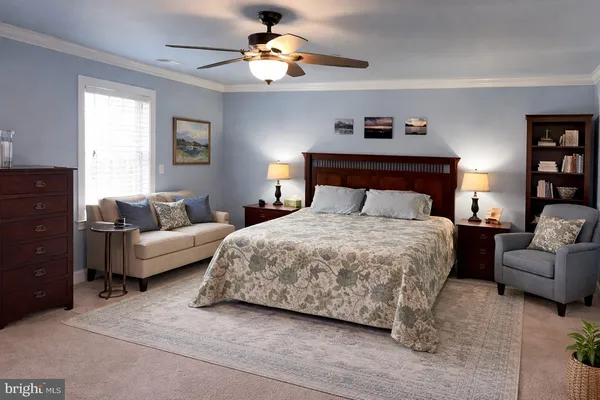 a bedroom with a bed a couch and a window