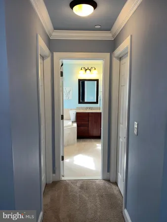 a view of a hallway and a livingroom with furniture