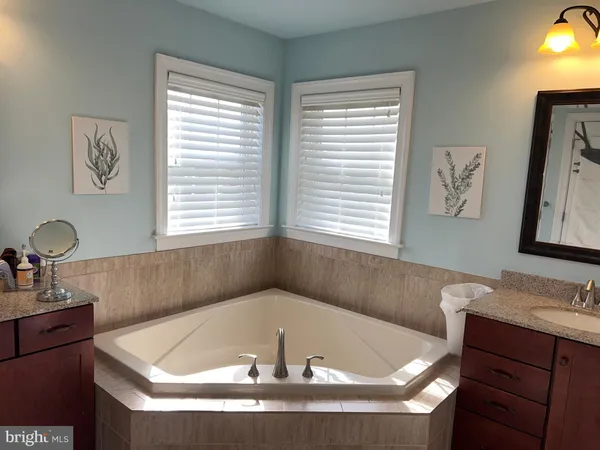 a bath tub sitting in a bathroom next to a window