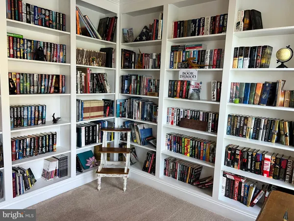 a living room with furniture lots of books