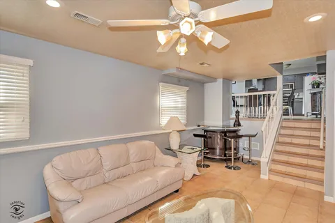 a living room with furniture and a chandelier