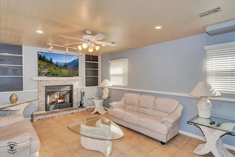 a living room with furniture a fireplace and a flat screen tv