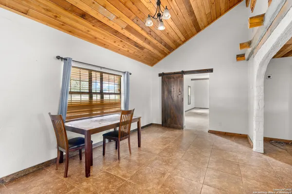 a dining room with furniture and window