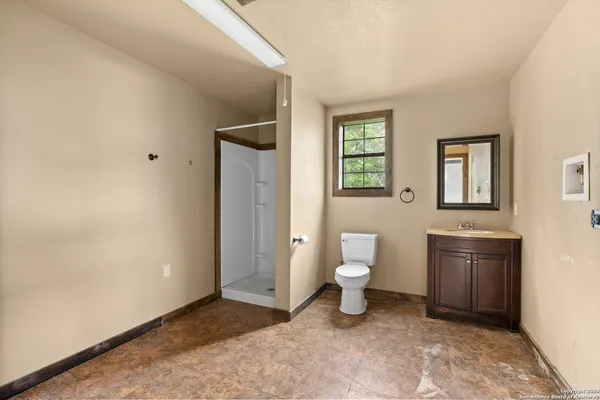 a bathroom with a toilet sink and a mirror