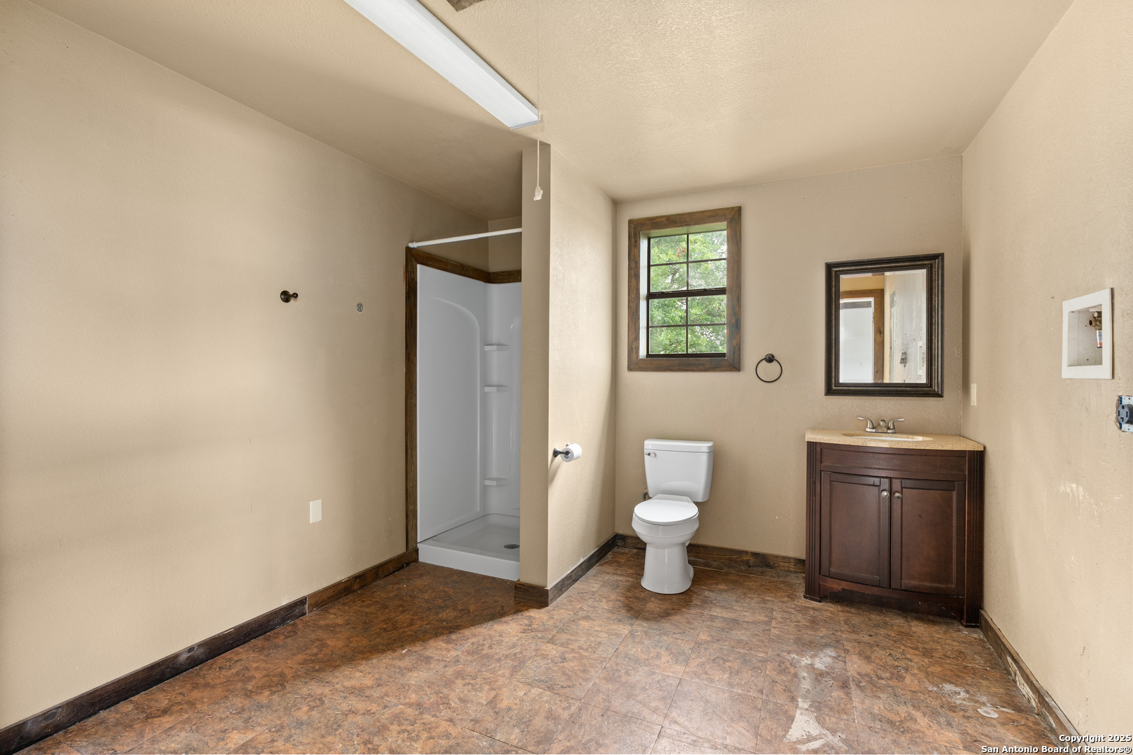 870 County Road 761 Devine, TX 78016 - Photo 18 of 34 a bathroom with a toilet sink and a mirror