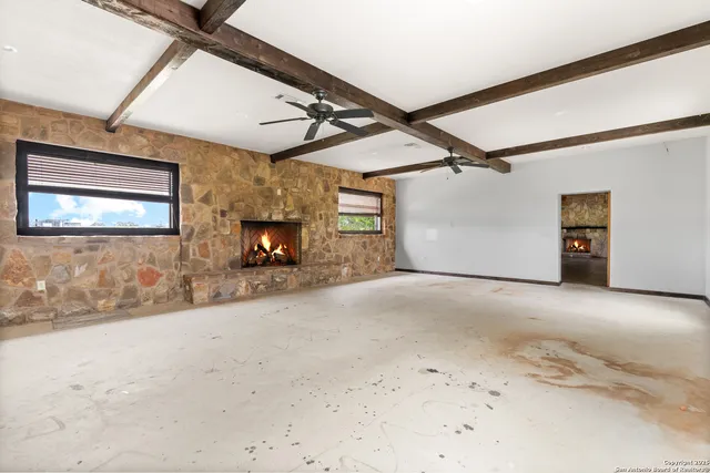 a view of a livingroom with an empty space and a fireplace