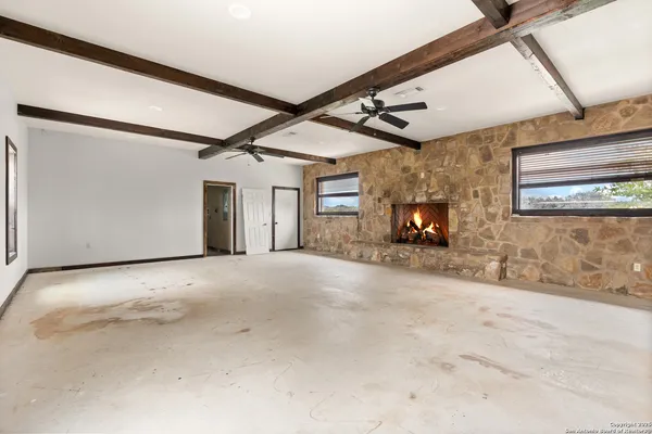 a view of a livingroom with wooden floor and a fireplace
