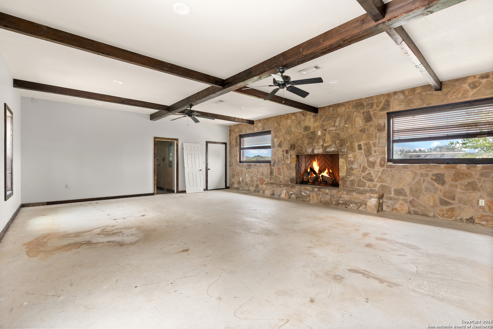 870 County Road 761 Devine, TX 78016 - Photo 20 of 34 a view of a livingroom with wooden floor and a fireplace