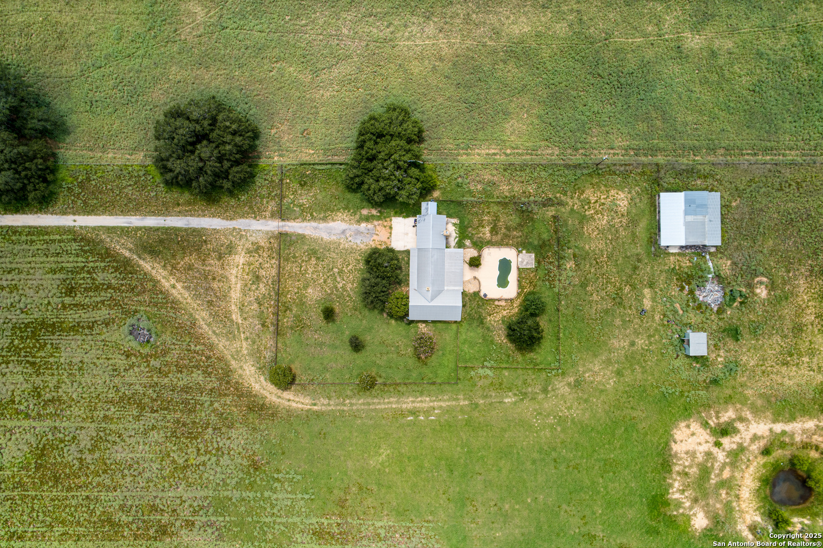 870 County Road 761 Devine, TX 78016 - Photo 2 of 34 a view of residential houses with swimming pool