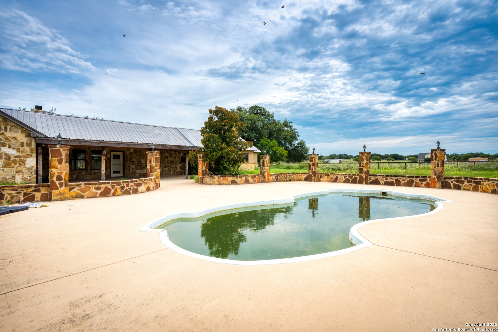 870 County Road 761 Devine, TX 78016 - Photo 22 of 34 a view of swimming pool with outdoor seating