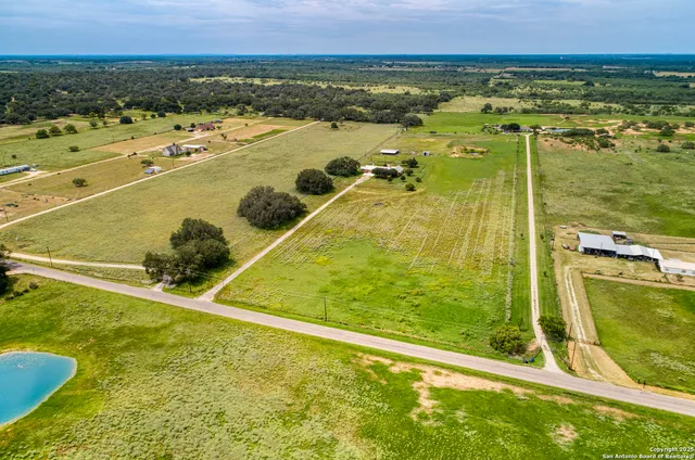 a view of a lake with a yard and trees