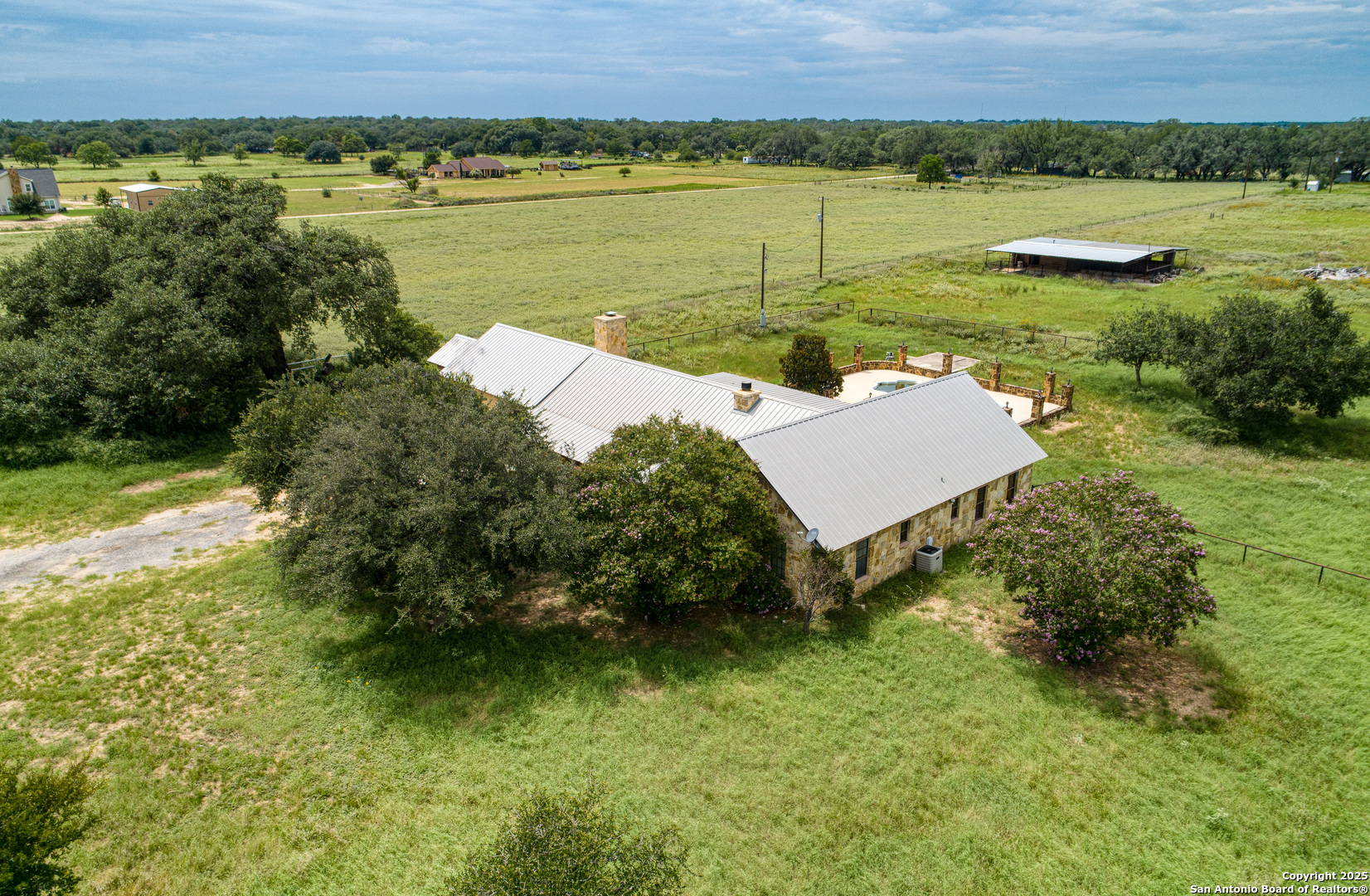 870 County Road 761 Devine, TX 78016 - Photo 29 of 34 a view of a lake with a yard and trees
