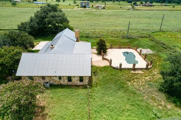 a view of a swimming pool with an outdoor seating and a yard