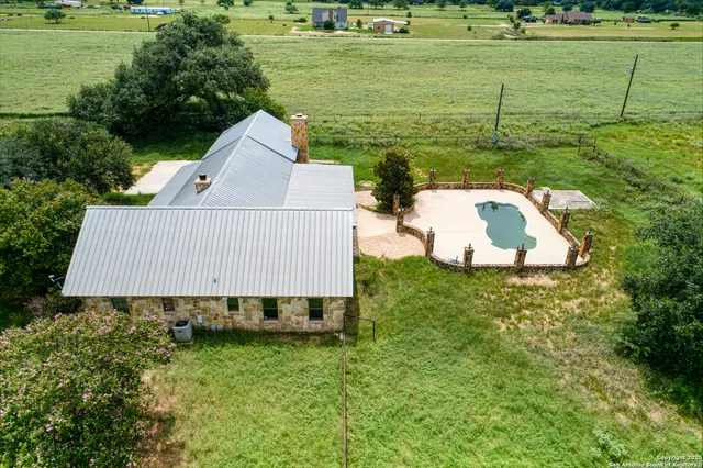 a view of a swimming pool with an outdoor seating and a yard