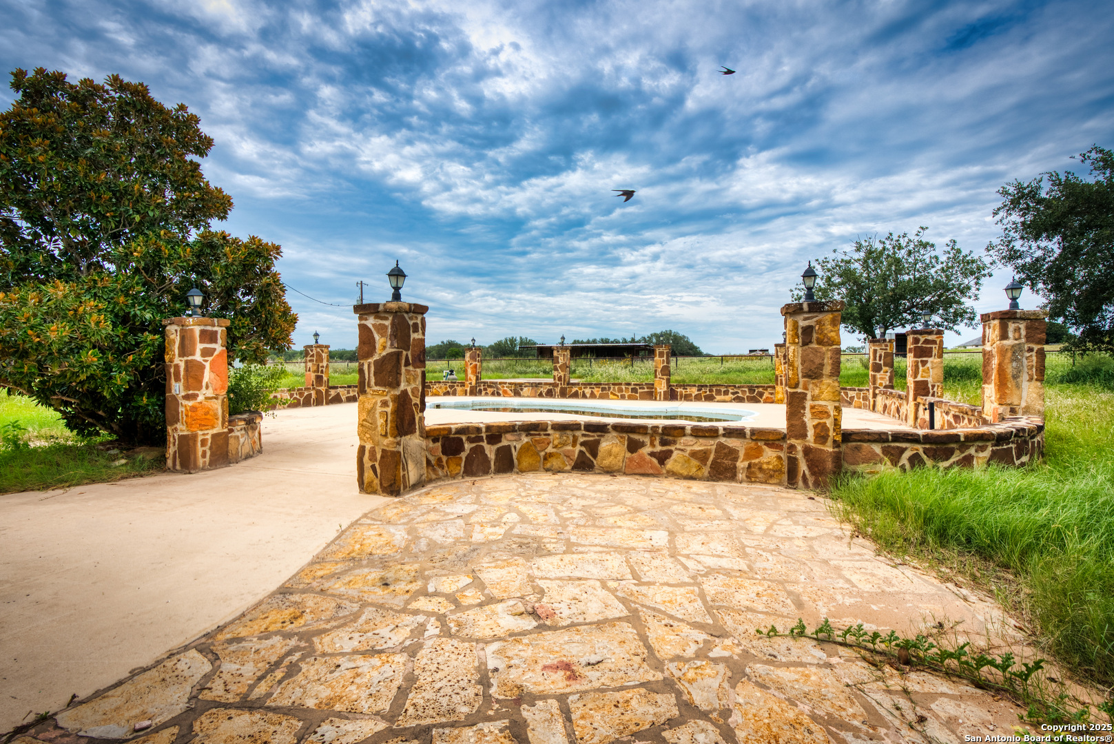 870 County Road 761 Devine, TX 78016 - Photo 33 of 34 a view of a swimming pool with an outdoor seating and a yard