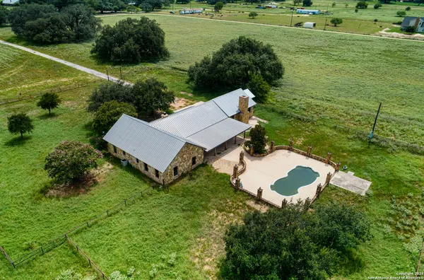 a view of a house with a yard and lake view