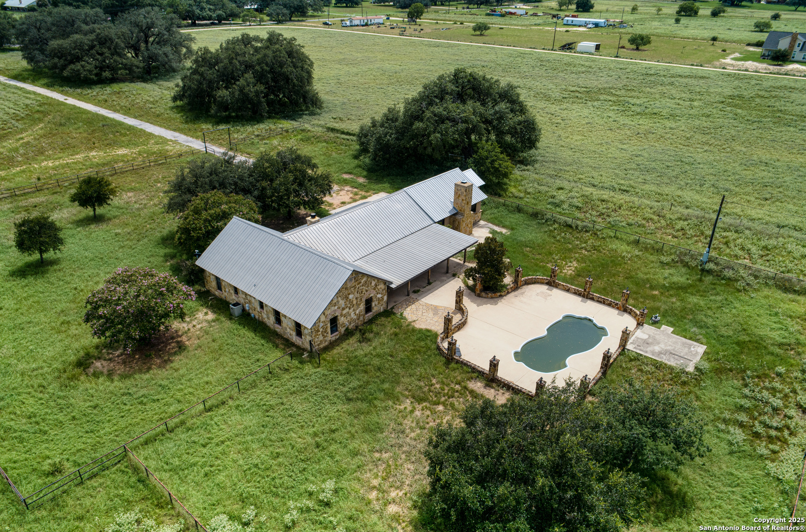 870 County Road 761 Devine, TX 78016 - Photo 4 of 34 a view of a house with a yard and lake view