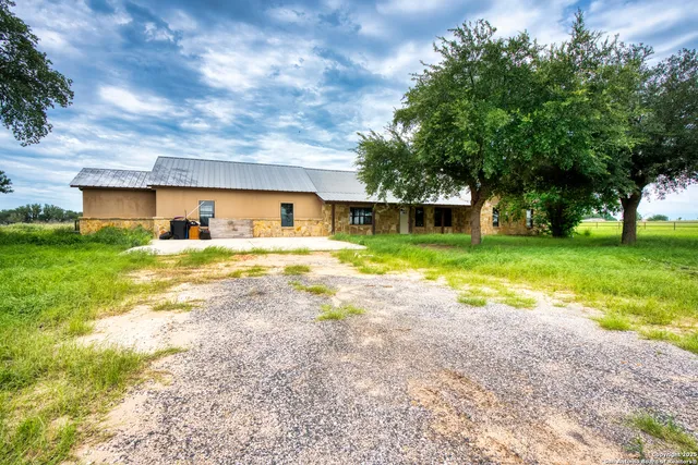 a view of a house with swimming pool and a yard