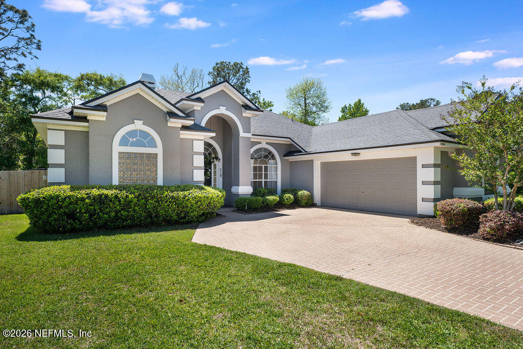 1984 Bluebonnet Way Fleming Island, FL 32003 - Photo 2 of 69 a front view of a house with a yard