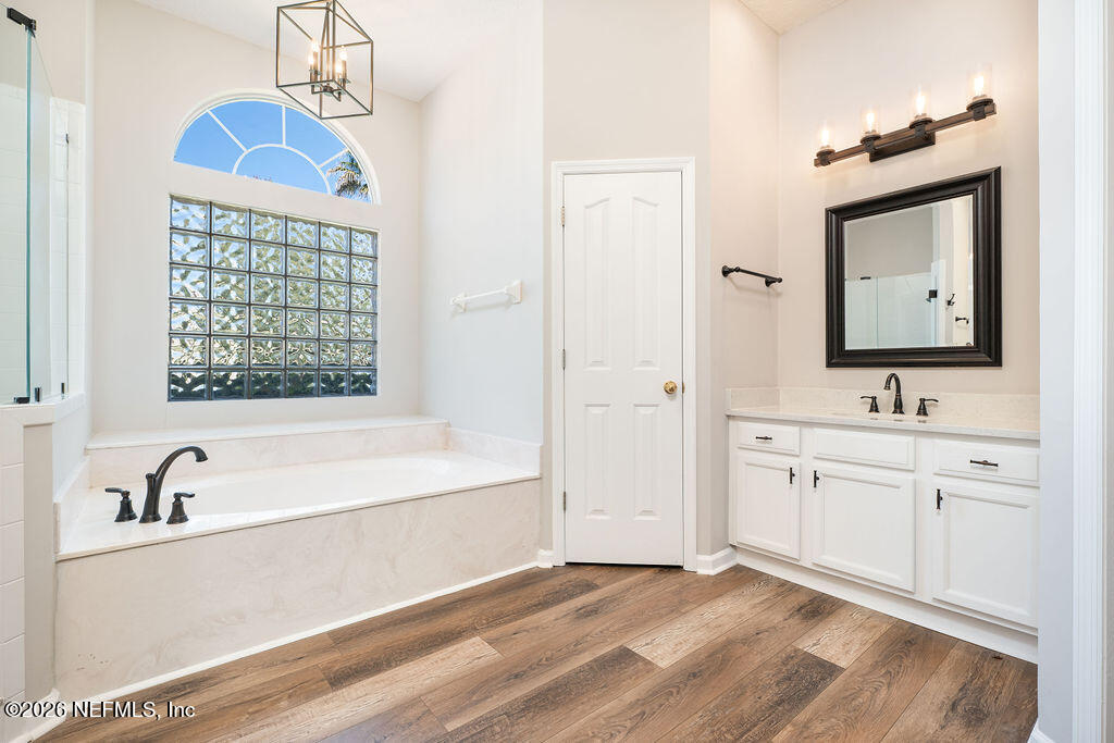 1984 Bluebonnet Way Fleming Island, FL 32003 - Photo 23 of 69 a bathroom with a tub sink and mirror