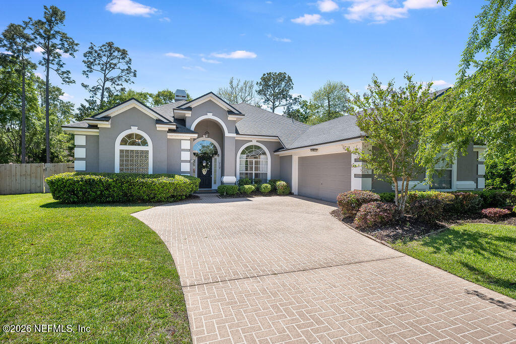 1984 Bluebonnet Way Fleming Island, FL 32003 - Photo 3 of 69 a front view of a house with a yard and garage