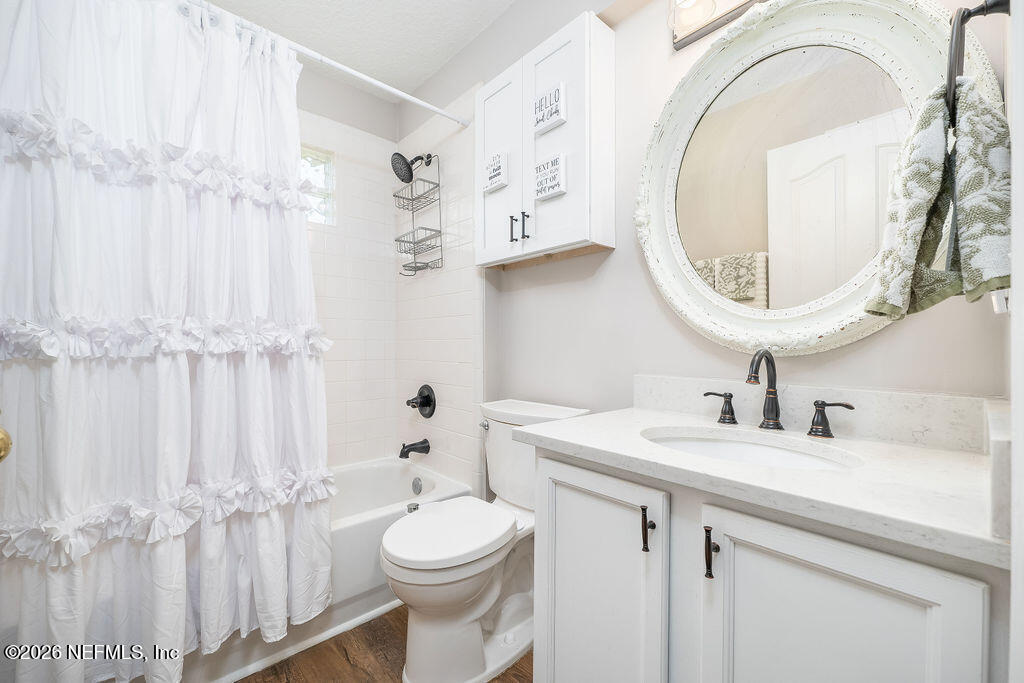 1984 Bluebonnet Way Fleming Island, FL 32003 - Photo 32 of 69 a bathroom with a sink a toilet and a mirror