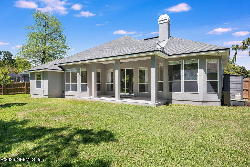 1984 Bluebonnet Way Fleming Island, FL 32003 - Photo 37 of 69 a front view of a house with a garden