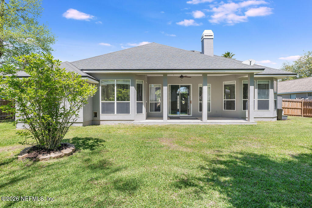 1984 Bluebonnet Way Fleming Island, FL 32003 - Photo 38 of 69 a front view of a house with a garden