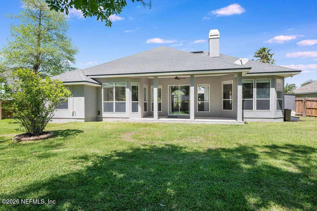 1984 Bluebonnet Way Fleming Island, FL 32003 - Photo 40 of 69 a front view of a house with a garden