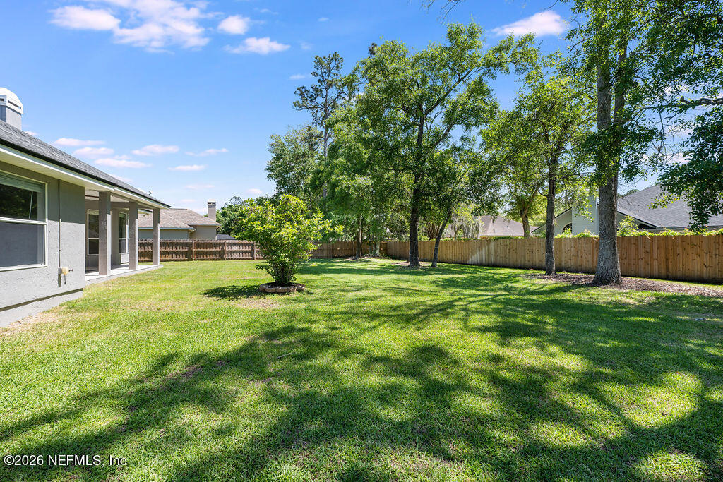 1984 Bluebonnet Way Fleming Island, FL 32003 - Photo 42 of 69 a view of a yard with a large tree
