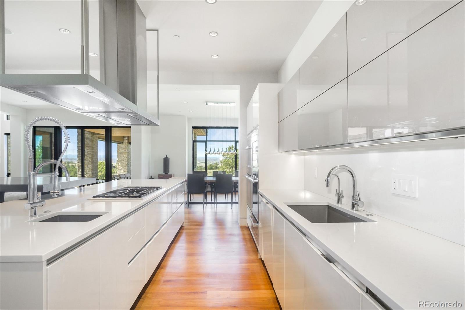 7895 Forest Keep Circle Parker, CO 80134 - Photo 12 of 40 a large kitchen with kitchen island a sink a counter space appliances and cabinets