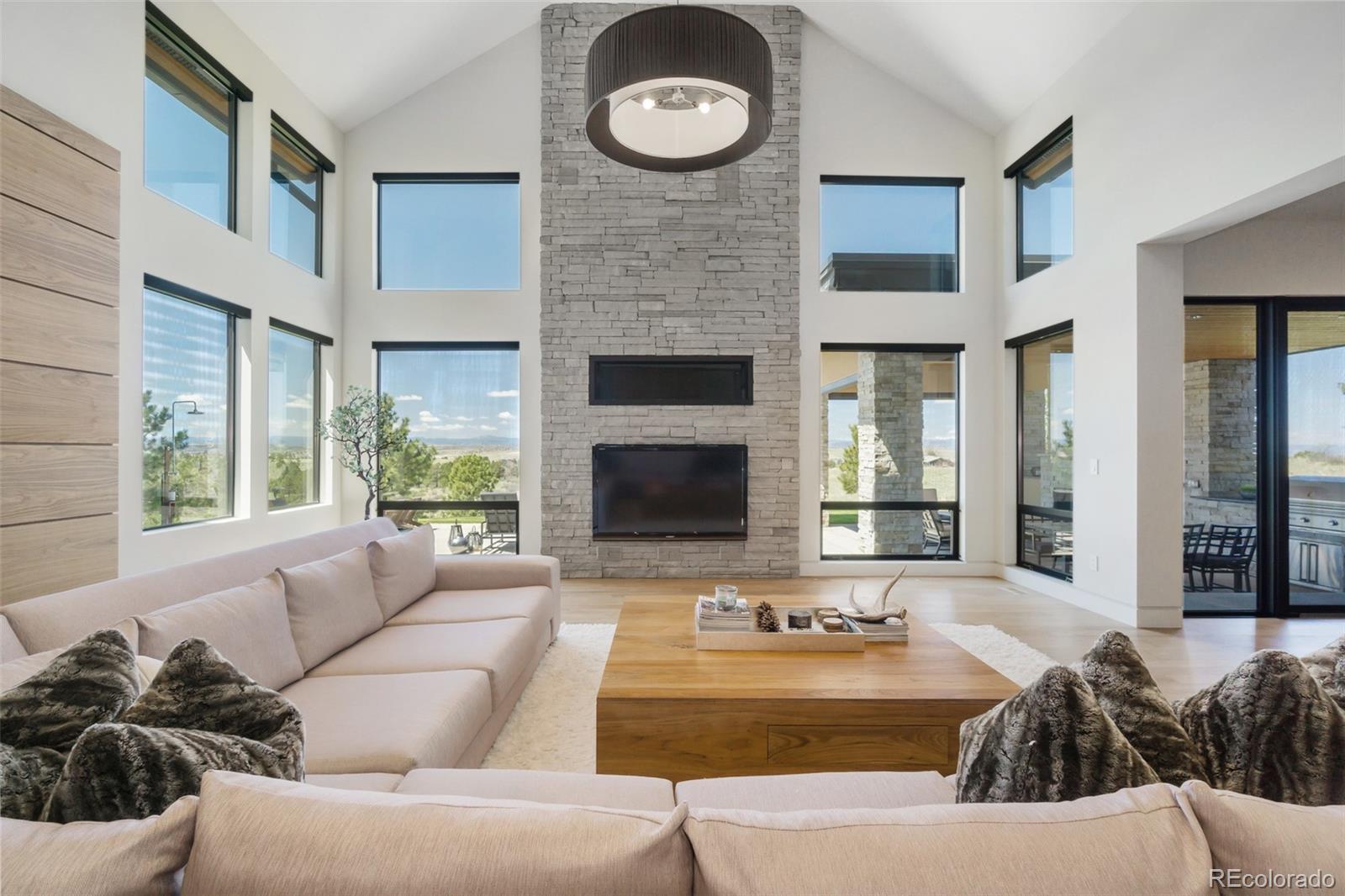 7895 Forest Keep Circle Parker, CO 80134 - Photo 16 of 40 a living room with furniture and a fireplace
