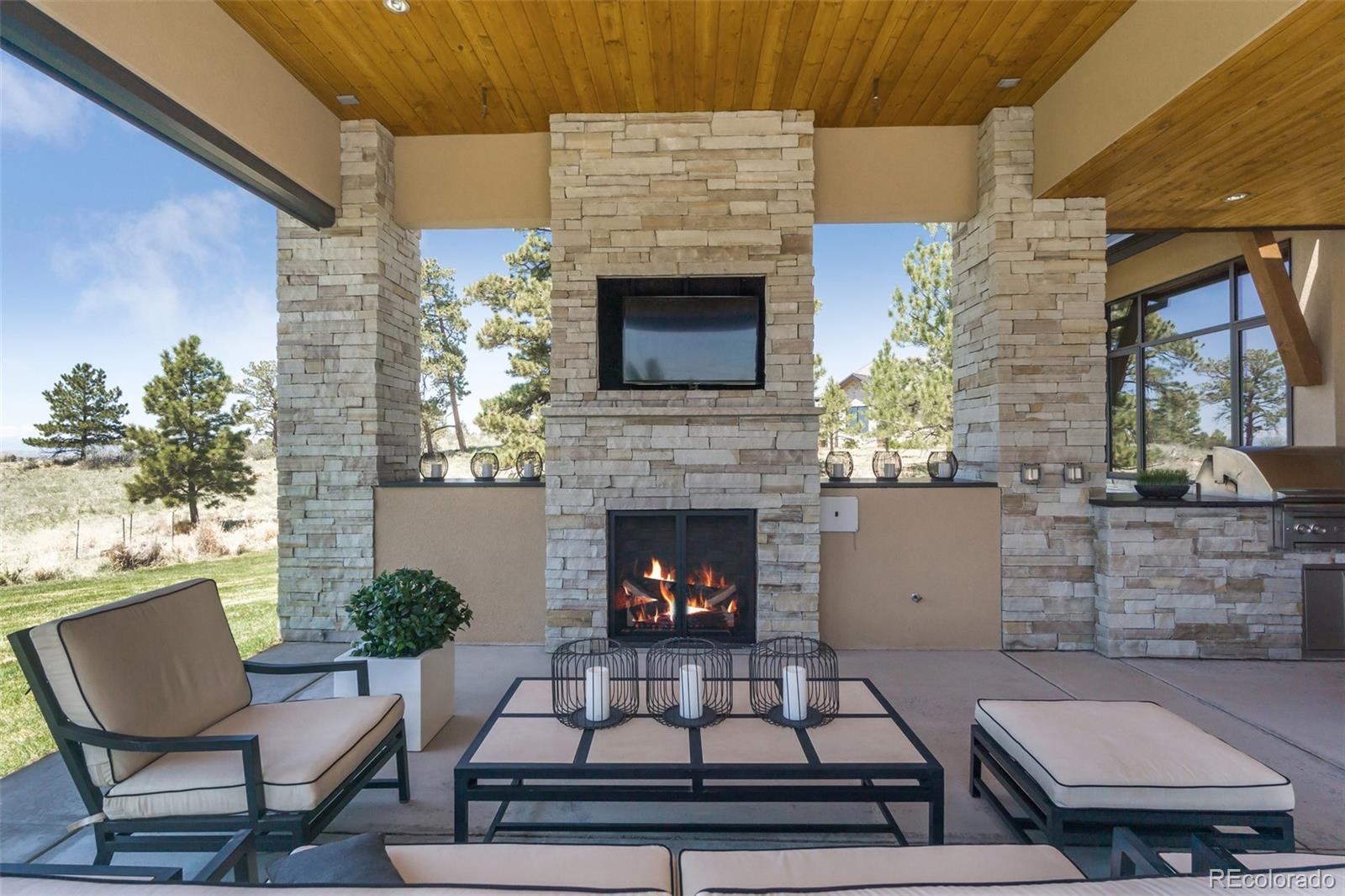 7895 Forest Keep Circle Parker, CO 80134 - Photo 21 of 40 a living room with furniture and a fireplace