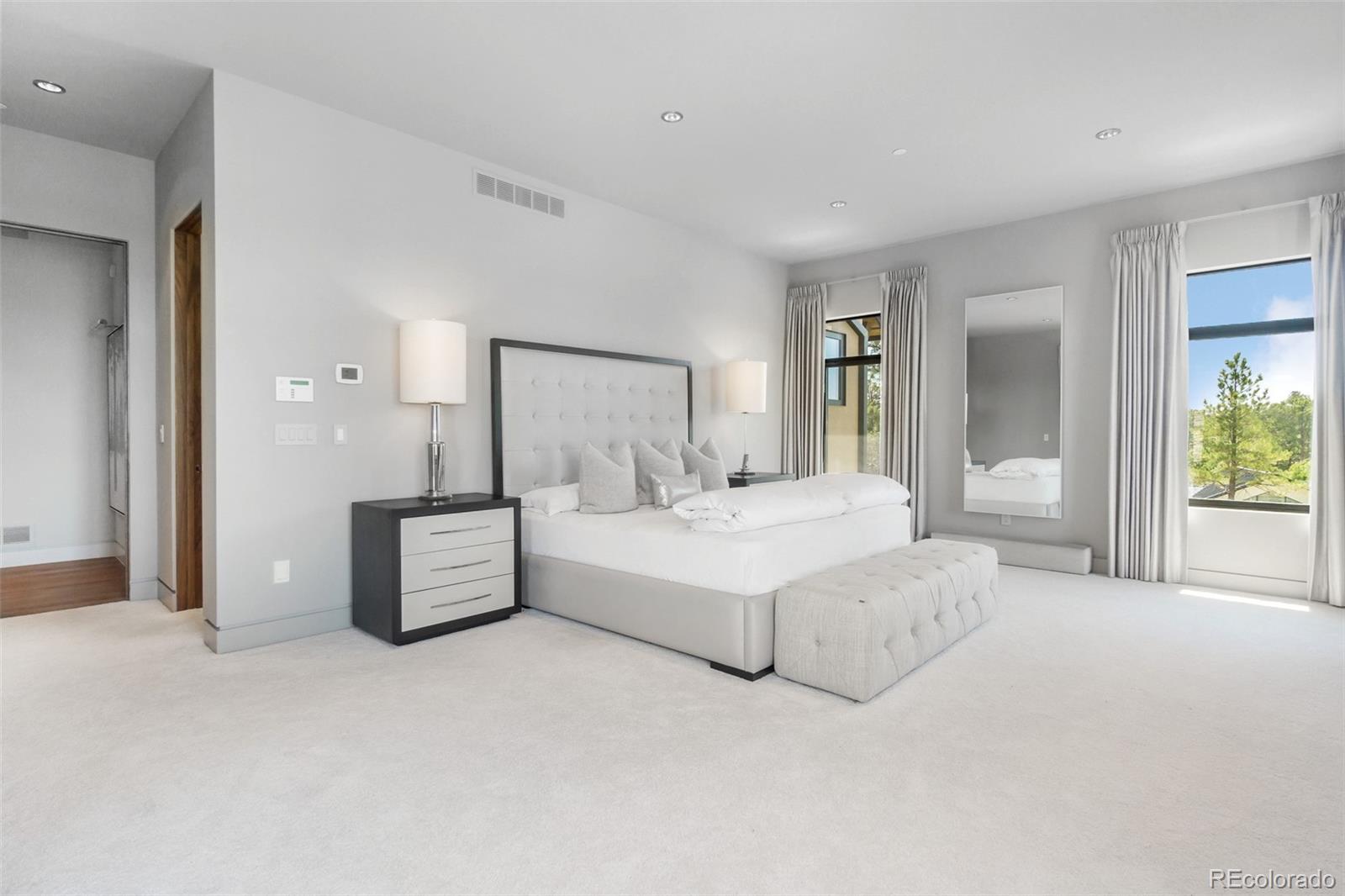 7895 Forest Keep Circle Parker, CO 80134 - Photo 25 of 40 a spacious bedroom with a bed and a night stand