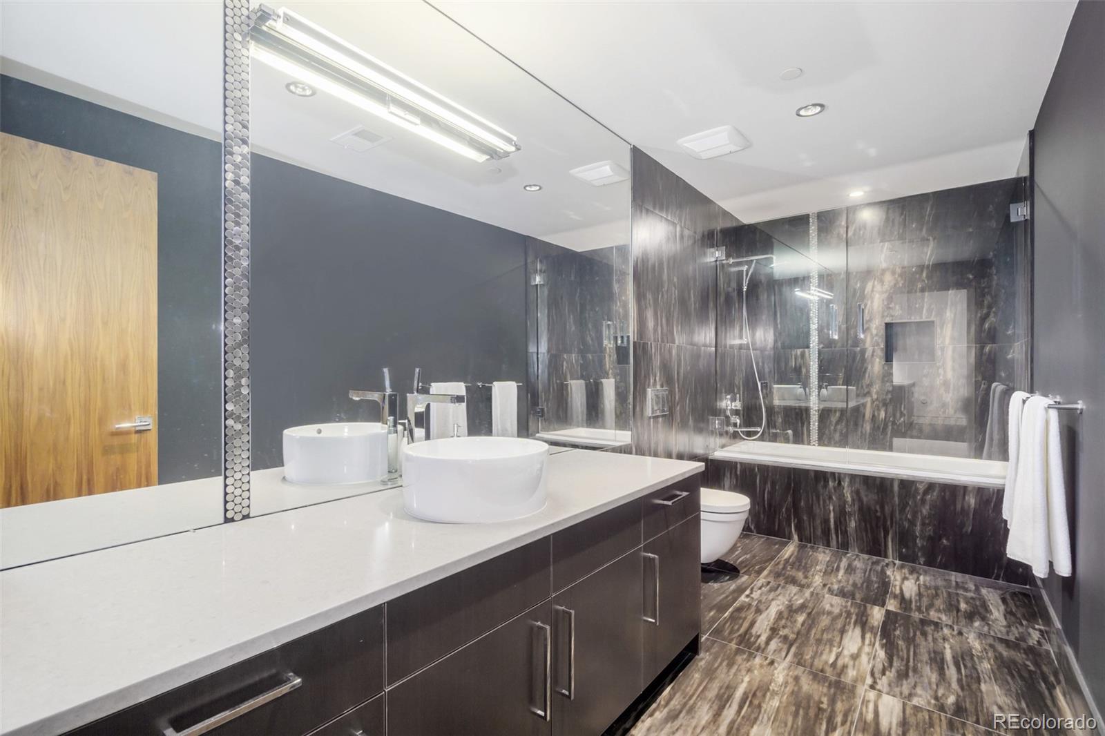 7895 Forest Keep Circle Parker, CO 80134 - Photo 30 of 40 a large bathroom with a double vanity sink and a large mirror