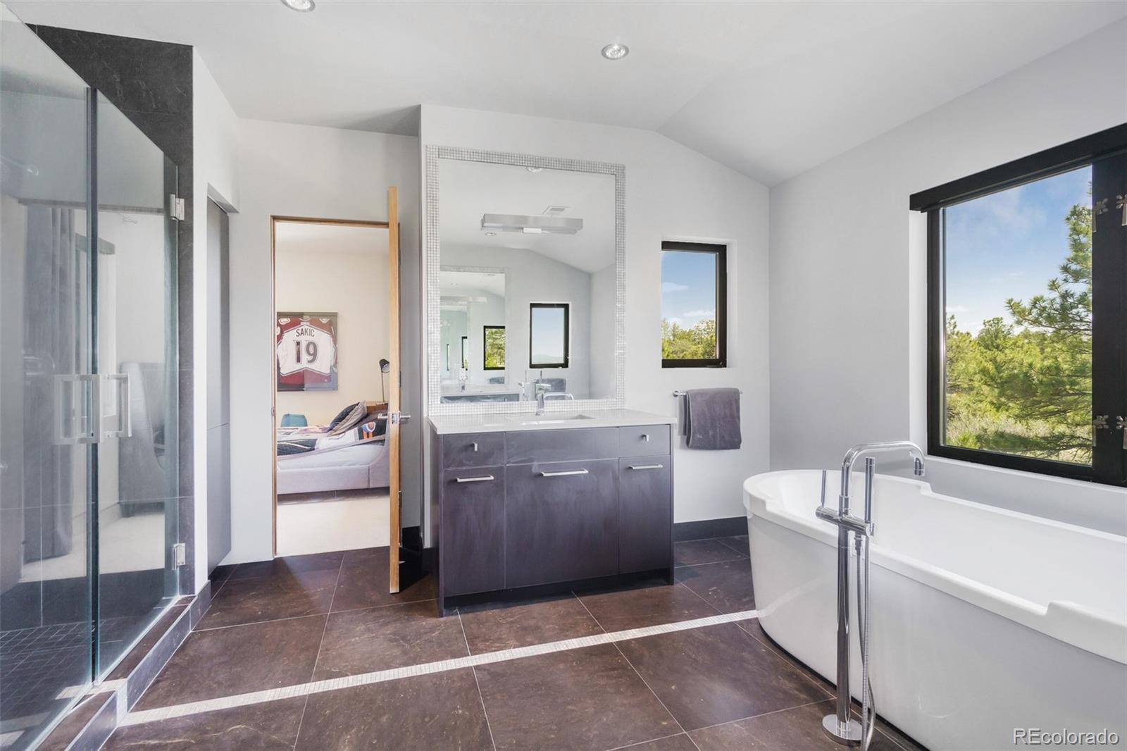 7895 Forest Keep Circle Parker, CO 80134 - Photo 32 of 40 a bathroom with a bathtub shower and a sink