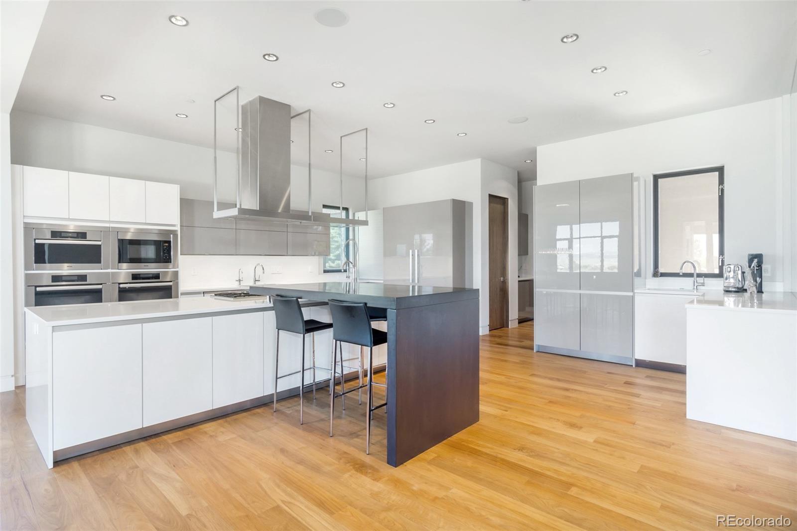 7895 Forest Keep Circle Parker, CO 80134 - Photo 9 of 40 a kitchen with kitchen island stainless steel appliances a stove refrigerator sink and cabinets