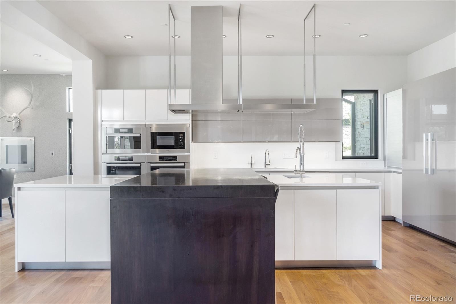 7895 Forest Keep Circle Parker, CO 80134 - Photo 10 of 40 a kitchen with stainless steel appliances granite countertop a sink a stove and a refrigerator