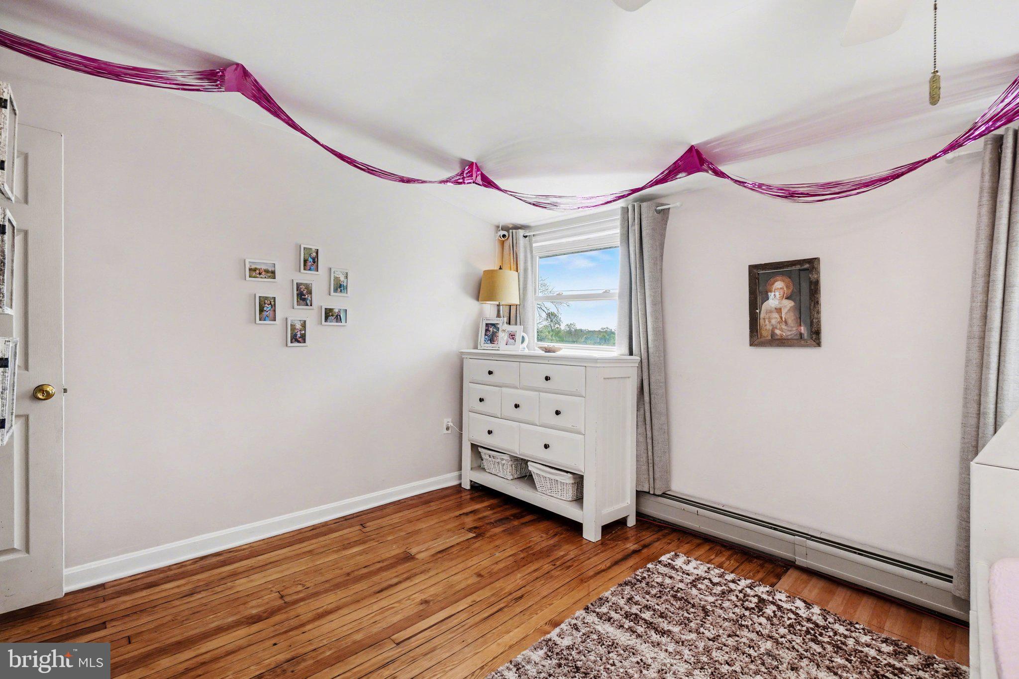 321 Walnut Street Lemoyne, PA 17043 - Photo 20 of 34 a bedroom with a bed and wooden floor