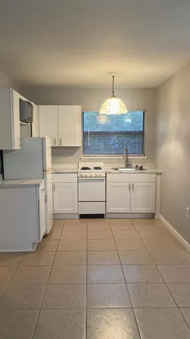 a kitchen with a stove a sink and a refrigerator