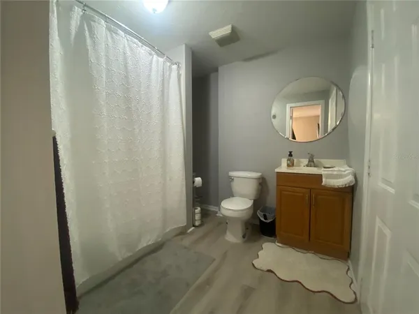 a bathroom with a toilet a sink and a mirror